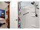 Clean shower with a shower head and safety bar, seen through a doorway from a bedroom at 7655 N Kitchen Rd, Mooresville, IN 46158