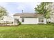 Spacious backyard featuring a well-maintained lawn, mature trees, and a charming outdoor deck at 7703 Park North Lake Dr, Indianapolis, IN 46260