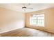 Bright bedroom with ceiling fan, wood-look flooring, and a large window at 7703 Park North Lake Dr, Indianapolis, IN 46260