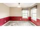Traditional dining room features wainscoting, neutral paint, and windows offering ample natural light at 7703 Park North Lake Dr, Indianapolis, IN 46260