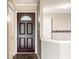Spacious entryway with a dark wood door and neutral walls at 7703 Park North Lake Dr, Indianapolis, IN 46260