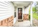 Inviting covered front porch with brick accents and well-maintained front door at 7703 Park North Lake Dr, Indianapolis, IN 46260