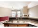 Kitchen with stainless steel sink and stone countertops overlooking the dining area at 7703 Park North Lake Dr, Indianapolis, IN 46260