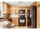 Kitchen features stainless steel appliances, wooden cabinets, and tile backsplash at 7703 Park North Lake Dr, Indianapolis, IN 46260