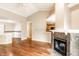 Open living room with wood floors, a corner fireplace, and eat-in kitchen at 7703 Park North Lake Dr, Indianapolis, IN 46260