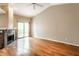 Open living room featuring hardwood floors, a stone fireplace, and sliding door at 7703 Park North Lake Dr, Indianapolis, IN 46260