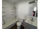 Bright bathroom features a tub with shower, modern sink, and gray vanity at 810 S 18 Th St, Elwood, IN 46036