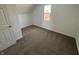 Bright bedroom featuring neutral carpet, white walls, and a window at 810 S 18 Th St, Elwood, IN 46036