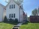 Quaint home with a red metal roof, tidy landscaping, and a welcoming front entrance at 810 S 18 Th St, Elwood, IN 46036