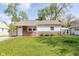 Charming single-story home featuring a well-maintained lawn and a classic brick and siding facade at 8144 E 50Th St, Indianapolis, IN 46226
