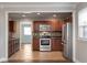 Open kitchen layout with stainless steel appliances, rich wood cabinets, and a tiled backsplash at 8144 E 50Th St, Indianapolis, IN 46226