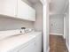 Bright laundry room with white cabinetry and tile flooring at 8144 E 50Th St, Indianapolis, IN 46226