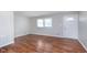 Bright living room featuring hardwood floors, a window, and a white front door at 8144 E 50Th St, Indianapolis, IN 46226