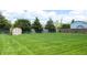 Large, well-maintained backyard featuring a wooden shed and a privacy fence at 8630 E Mcgregor Rd, Indianapolis, IN 46259