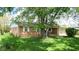 Well-kept brick home with a large tree in the front yard providing shade at 8630 E Mcgregor Rd, Indianapolis, IN 46259