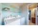 The laundry room includes a washer, dryer and wire shelving at 8630 E Mcgregor Rd, Indianapolis, IN 46259