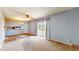 Cozy living area with sliding glass doors to the deck, and pass-through to the kitchen at 8630 E Mcgregor Rd, Indianapolis, IN 46259