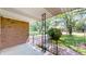 Covered front porch featuring brick siding and wrought iron railing at 8630 E Mcgregor Rd, Indianapolis, IN 46259