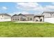 Lovely backyard with a well-maintained lawn, patio, gazebo, grill, and privacy fence surrounding the yard at 89 Kinnick Dr, Greenwood, IN 46143