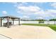 Spacious backyard patio with gazebo, grill, and view of a small lake surrounded by a privacy fence at 89 Kinnick Dr, Greenwood, IN 46143