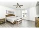 Bright bedroom with neutral tones boasts a ceiling fan, ample natural light, and elegant furniture at 89 Kinnick Dr, Greenwood, IN 46143