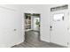 A bright entryway with wood-look floors leading to the open-concept living space at 89 Kinnick Dr, Greenwood, IN 46143