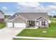 Beautiful single-story brick home with manicured lawn and three-car garage near a serene pond at 89 Kinnick Dr, Greenwood, IN 46143