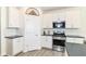 Well-lit kitchen features white cabinets, stainless steel appliances, and modern fixtures at 89 Kinnick Dr, Greenwood, IN 46143