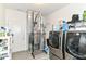 Well-equipped laundry room features modern, front-loading washer and dryer with ample storage space and utility area at 89 Kinnick Dr, Greenwood, IN 46143