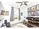 Cozy living room with a comfortable leather sofa, ceiling fan, and curated decor for relaxed living at 89 Kinnick Dr, Greenwood, IN 46143