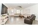 Open-concept living room featuring hardwood floors, neutral decor, and a comfortable seating area at 89 Kinnick Dr, Greenwood, IN 46143