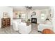 Bright living room boasts a fireplace, ceiling fan, and seamless flow into the kitchen and dining areas at 89 Kinnick Dr, Greenwood, IN 46143