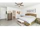 Inviting main bedroom with ceiling fan, gray plank floors, and an en-suite bathroom for added privacy at 89 Kinnick Dr, Greenwood, IN 46143