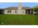 Backyard view of vinyl siding, a chimney, and a screened in porch at 9125 Bagley Way, Indianapolis, IN 46231