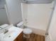 Bathroom with a standard white sink and toilet, and shower-tub combo at 9125 Bagley Way, Indianapolis, IN 46231
