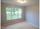 This bedroom is bright, featuring neutral carpet, a large window and fresh paint at 9125 Bagley Way, Indianapolis, IN 46231
