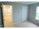 This bedroom is well-lit and spacious, with neutral carpet and a view down the hallway at 9125 Bagley Way, Indianapolis, IN 46231