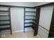 Walk-in closet with dark wood shelving and hanging rods for maximum storage at 9125 Bagley Way, Indianapolis, IN 46231