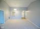 Spacious living room with carpet flooring, a vaulted ceiling, and an open entryway at 9125 Bagley Way, Indianapolis, IN 46231