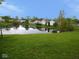 Scenic pond view surrounded by well-maintained lawns and residential houses at 9125 Bagley Way, Indianapolis, IN 46231