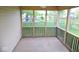 Screened-in porch overlooking a backyard with a deck and storage shed at 9125 Bagley Way, Indianapolis, IN 46231