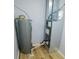 Utility room featuring a new water heater and furnace system, along with painted walls and wood-look flooring at 9125 Bagley Way, Indianapolis, IN 46231