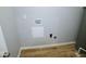 Utility room features hookups and water access, along with painted walls and wood-look flooring at 9125 Bagley Way, Indianapolis, IN 46231
