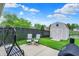 Serene backyard with view of pond, shed, and lounge seating at 917 Congressional Way, Shelbyville, IN 46176
