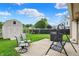 Relaxing backyard with comfortable seating, a shed, and a view of the pond at 917 Congressional Way, Shelbyville, IN 46176