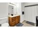 Clean bathroom with a vanity, mirror, and shower-tub combination with a shower curtain at 917 Congressional Way, Shelbyville, IN 46176