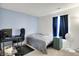 Comfortable bedroom with desk and fan, bathed in natural light from a nearby window at 917 Congressional Way, Shelbyville, IN 46176