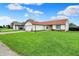 View of the house from the street showcasing the spacious front lawn and two-car garage at 917 Congressional Way, Shelbyville, IN 46176