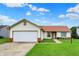 Charming single-story home with a well-manicured lawn, attached two-car garage, and brick accents at 917 Congressional Way, Shelbyville, IN 46176