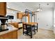 Bright kitchen featuring wood cabinets, white appliances, a skylight, and a butcher block island with seating at 917 Congressional Way, Shelbyville, IN 46176